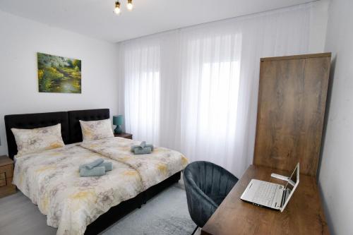 1 dormitorio con 1 cama y escritorio con ordenador portátil en Commodious house in Rijeka with 5 bedrooms, en Rijeka