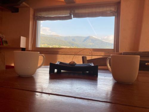 a room with a table with a large window at Antico fienile in Belluno