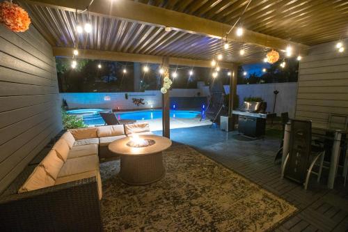 a patio with a couch and a table and a pool at 1800 SqFt House W/Heated Pool Spa 13Min From Strip in Las Vegas