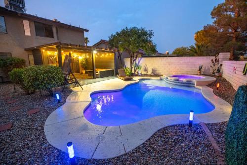 a swimming pool in the backyard of a house at 1800 SqFt House W/Heated Pool Spa 13Min From Strip in Las Vegas