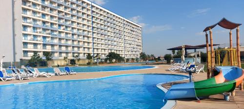 a large hotel with a swimming pool and a resort at Camera de închiriat Blaxy Premium Resort in Olimp