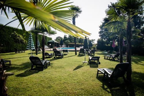 a group of chairs and umbrellas in a park at Agriturismo Parco Campofelice in Lombardore