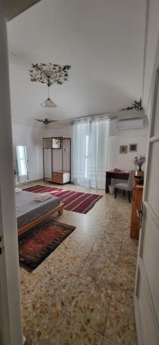 a large room with a bed and a table at Casa Maravì in Catania