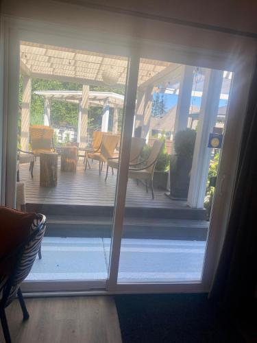 an open door to a porch with a table and chairs at Rockwood House in Nanaimo