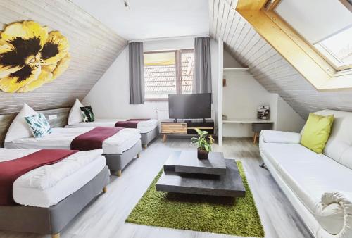 a living room with two beds and a couch at Das Waldhaus in Forbach