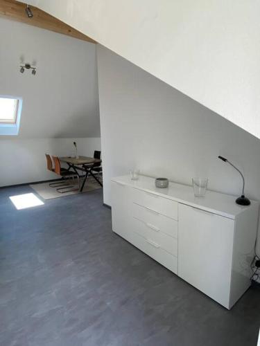 a living room with white cabinets and a table at Ferienwohnung Louis in Passau