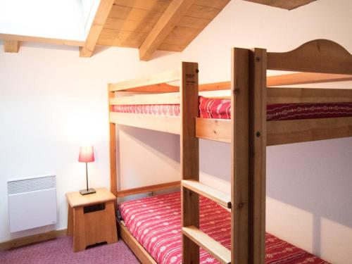 une chambre avec deux lits superposés et une lampe dans l'établissement Duplex pour 10 pers, au pied des pistes, proche télécabine et commerces, parking inclus - FR-1-508-16, à Lanslevillard
