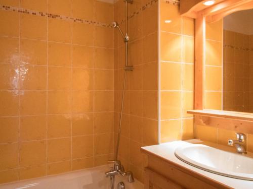 a bathroom with a shower and a sink and a tub at Appartement Lanslevillard, 4 pièces, 10 personnes - FR-1-508-16 in Lanslevillard