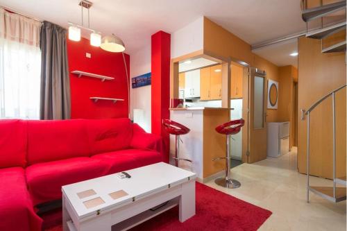 マラガにあるSUNBURN, Aquí Hay Quíen Vivaのリビングルーム(赤いソファ付)、キッチン