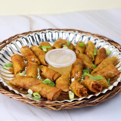 a basket filled with fried food with a dipping sauce at Urban Oasis Resort, Tarlac in Tarlac