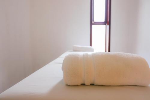 - une serviette blanche assise au sol dans une pièce dans l'établissement Mayan Secret Hotel Boutique, à Chetumal