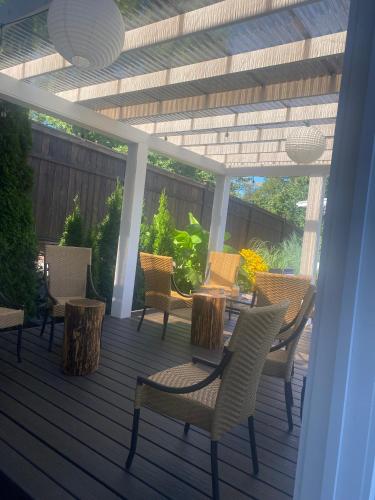 a patio with chairs and a table on a deck at Rockwood House in Nanaimo