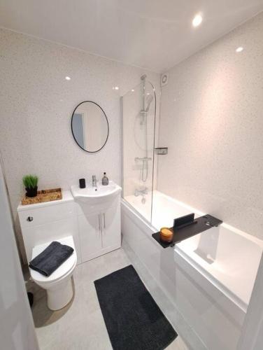 a bathroom with a toilet and a sink and a shower at Beachwood House, Serviced Accommodation in Brumby