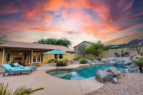 a home with a swimming pool with a patio and a house at Western Star Ahwatukee home in Phoenix