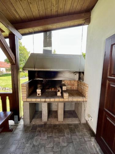an outdoor grill in a patio with a window at Kaproun - Studený pramen in Kunžak