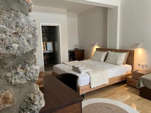 a bedroom with a bed and a living room at Olympus Stone Lodge in Litochoro