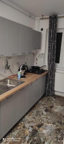 a kitchen with a sink and a counter top at Apartament Turda Cristina in Turda