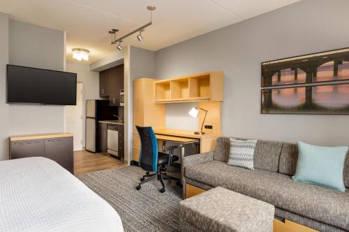 a hotel room with a bed and a desk and a couch at TownePlace Suites by Marriott Harrisburg West/Mechanicsburg in Mechanicsburg