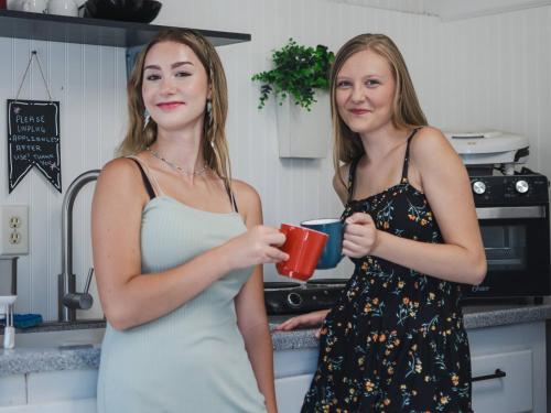 two women standing in a kitchen holding a coffee mug at Genas's Sierra Inn & Restaurant in Dunlap