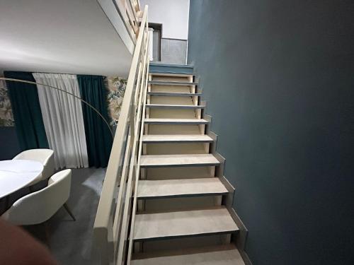 a staircase in a room with a blue wall at A un passo dal Castello Maschio ANGIOINO Appartment in Naples