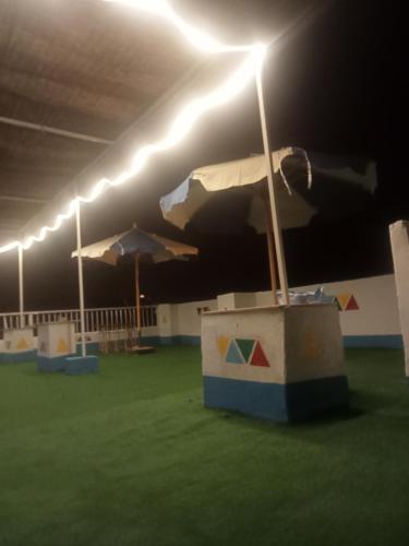 a room with lights on a field of grass at ABAZIDO Nubian Guest House in Aswan