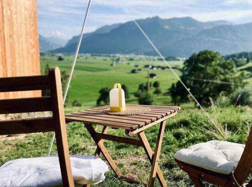 a picnic table with a candle on top of a field at Cabana auf dem Biohof Hornen 