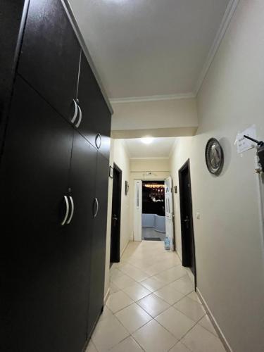 a hallway with black doors and a tile floor at Studio Apartments Rizarjo in Ksamil