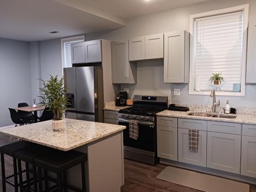 a kitchen with white cabinets and a counter top at La Villita - Gateway to Chicago in Chicago