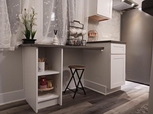 a kitchen with a counter and a stool in a room at La Villita - Gateway to Chicago in Chicago