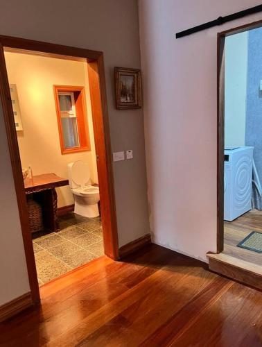 a bathroom with a toilet and a sink in a room at Rinneen in Newtown