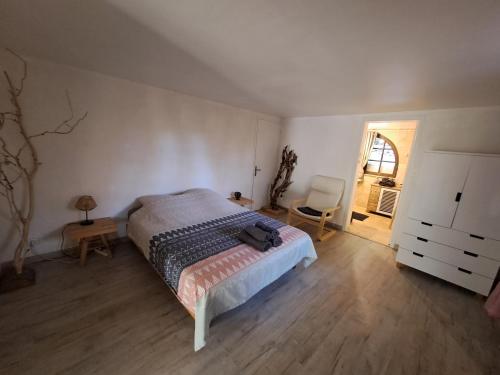 a bedroom with a bed and a desk and a chair at Bas de villa au chant des cigales in Lorgues