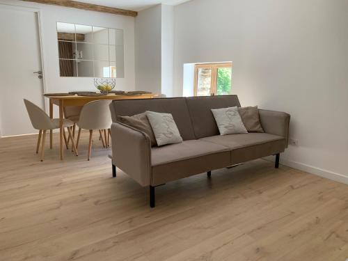 a living room with a couch and a table at Le Bois Dormans in Dormans