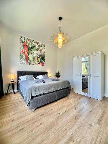 a bedroom with a bed and a painting on the wall at Exklusives City-Apartment im Herzen Oldenburgs mit Balkon und Parkplatz A36 in Oldenburg