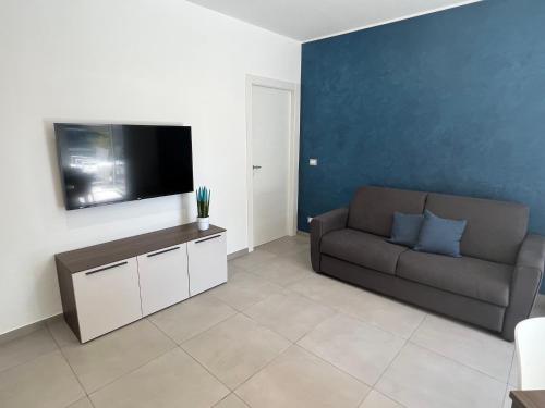 a living room with a couch and a flat screen tv at Centopassidamare in Formia