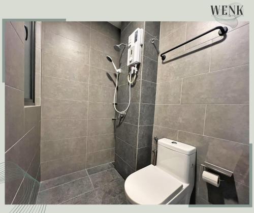 a bathroom with a toilet and a shower at Neu Suites @ 3RdNvenue A in Kuala Lumpur