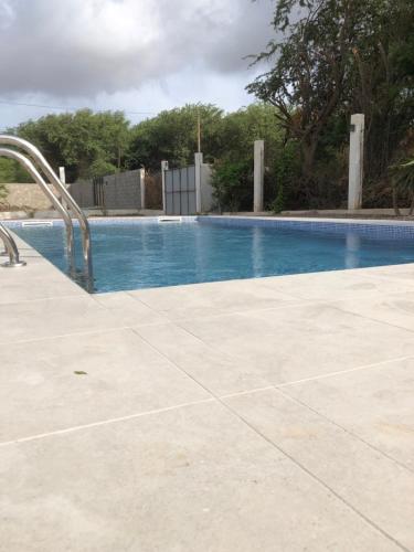 a large swimming pool with a blue pool at Casa Palmeira in Lazareto