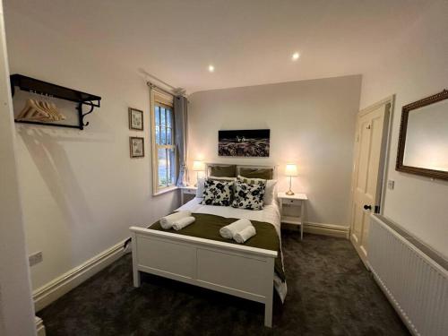 a bedroom with a bed with two pillows on it at The Burley at Scalford House in Melton Mowbray