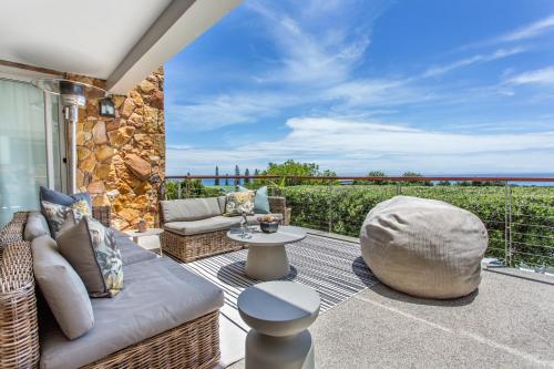 a patio with a couch and a table at Far Horizons Camps Bay in Cape Town