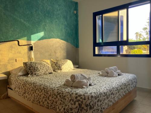 a bedroom with a bed with towels on it at Sea&Harbour Puerto del Carmen in Puerto del Carmen