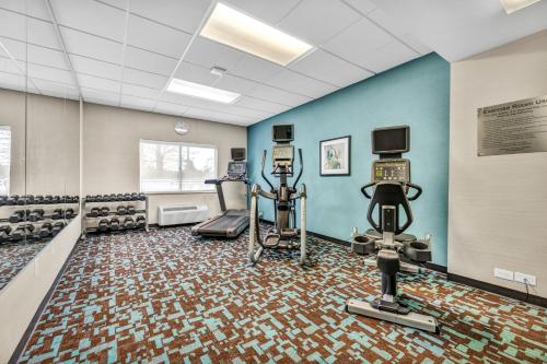 a gym with exercise equipment in a room with blue walls at Fairfield Inn by Marriott Lumberton in Lumberton