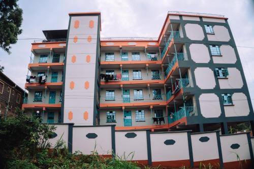 an apartment building with an orange and white building at Haven Air BnB Embu in Embu