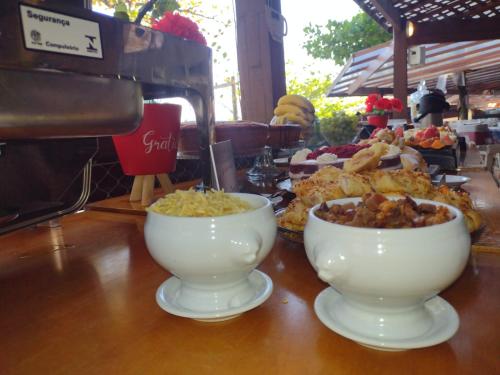 a table with two bowls of food on it at Pousada Camarote Itaipu in Niterói
