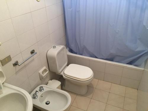 a bathroom with a white toilet and a sink at Vittorio Emanuele apartment in Canicattini Bagni