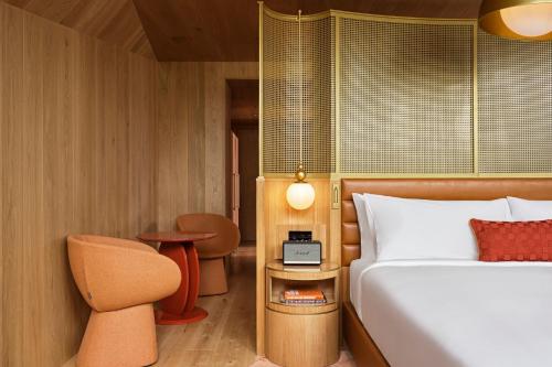 a bedroom with a bed and a table and a chair at W Budapest in Budapest