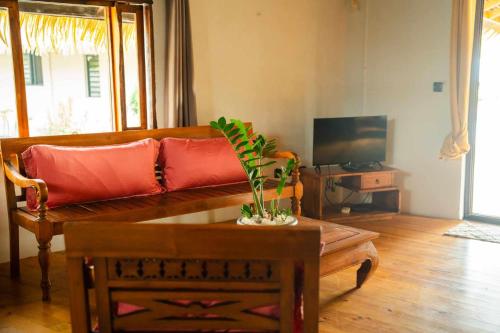 a living room with a couch and a coffee table at Le Village de Vairao in Vairao