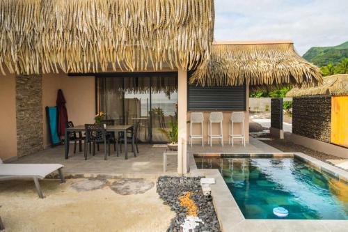 a resort with a swimming pool and a table and chairs at Le Village de Vairao in Vairao
