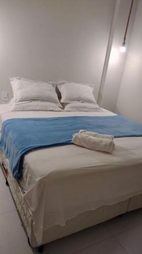 a large bed with blue and white sheets and pillows at Ap do Maro in Barreirinhas