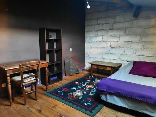 a bedroom with a bed and a desk and a table at Chambres de charme chez l'habitant in Baillargues