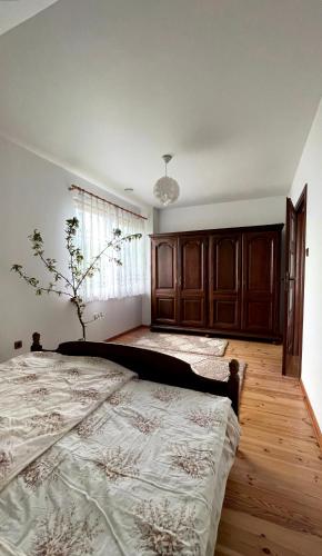 a bedroom with a large bed and a window at Dom z Widokiem w Rajgrodzie in Rajgród