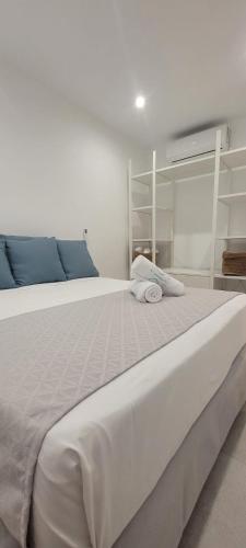 a large white bed with two pillows on it at Sabbia Suites Varadero in Puerto del Carmen